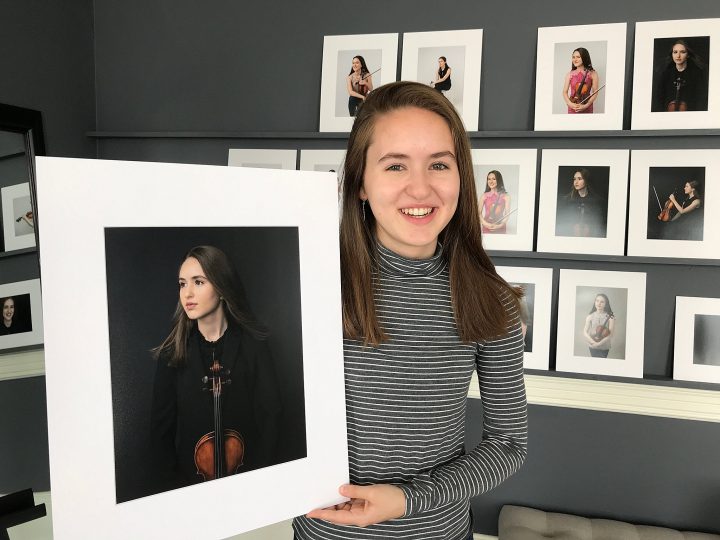 A high school senior with her favorite portraits