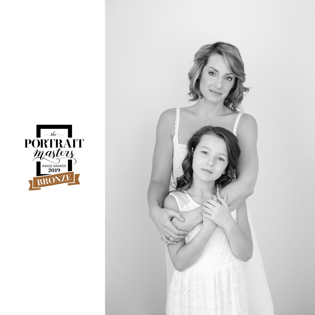Light colored black and white portrait of mother and daughter. Lisa and Leah.  Bronze award in the Family and group category