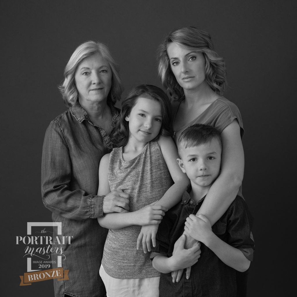 Black and white, three-generation family portrait.  Bronze award in Family portraiture.
