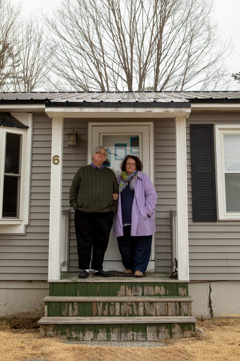 Jonathan and Marcia, outside their home