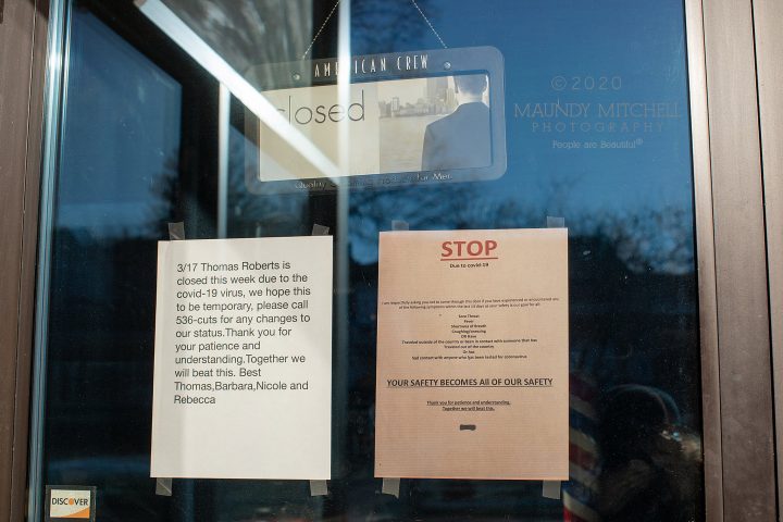 Signs in the window of a hair salon