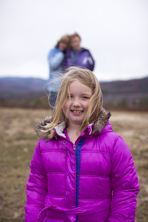 Girl in Foreground, Parents in Background