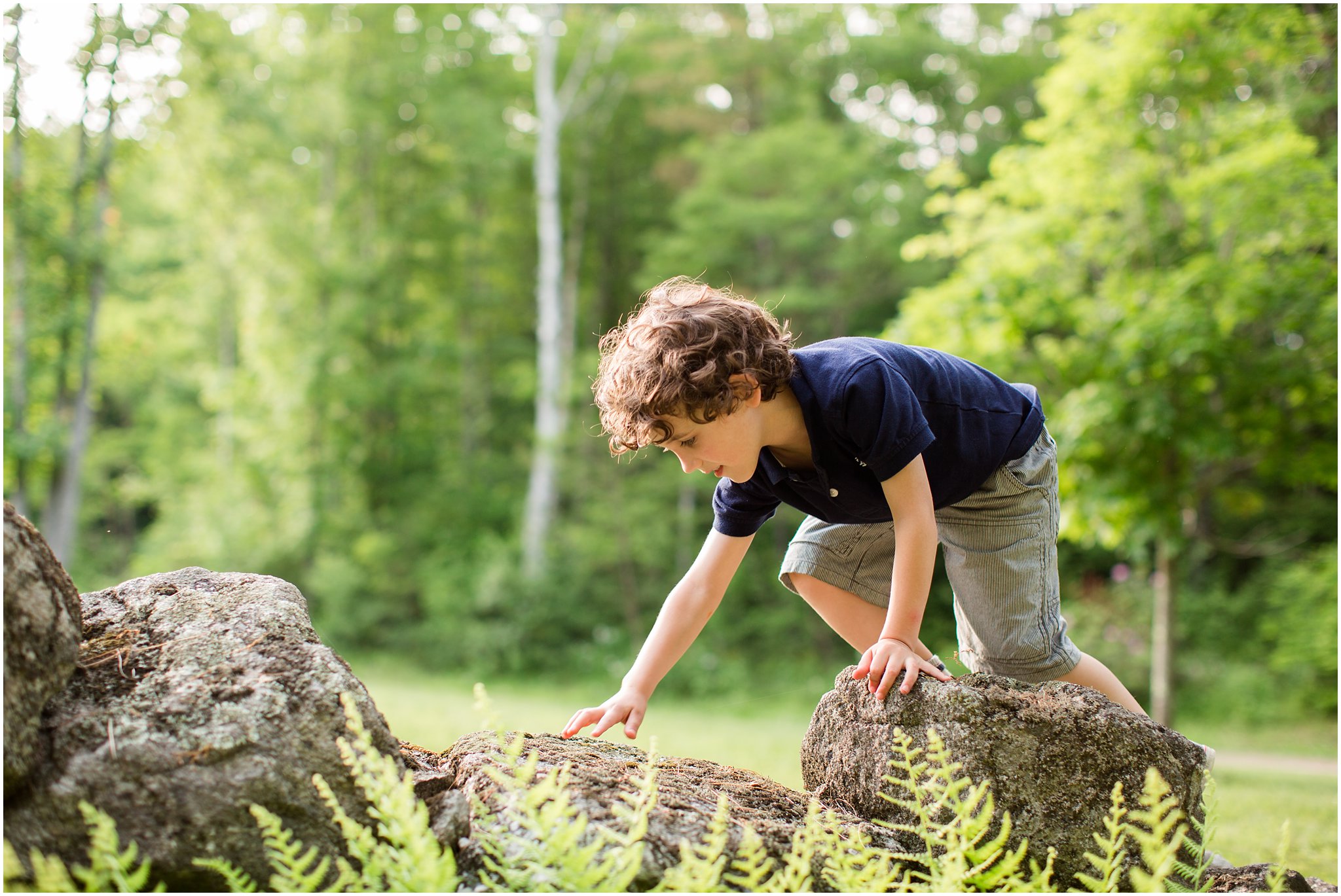 boy climbing stone wall 2