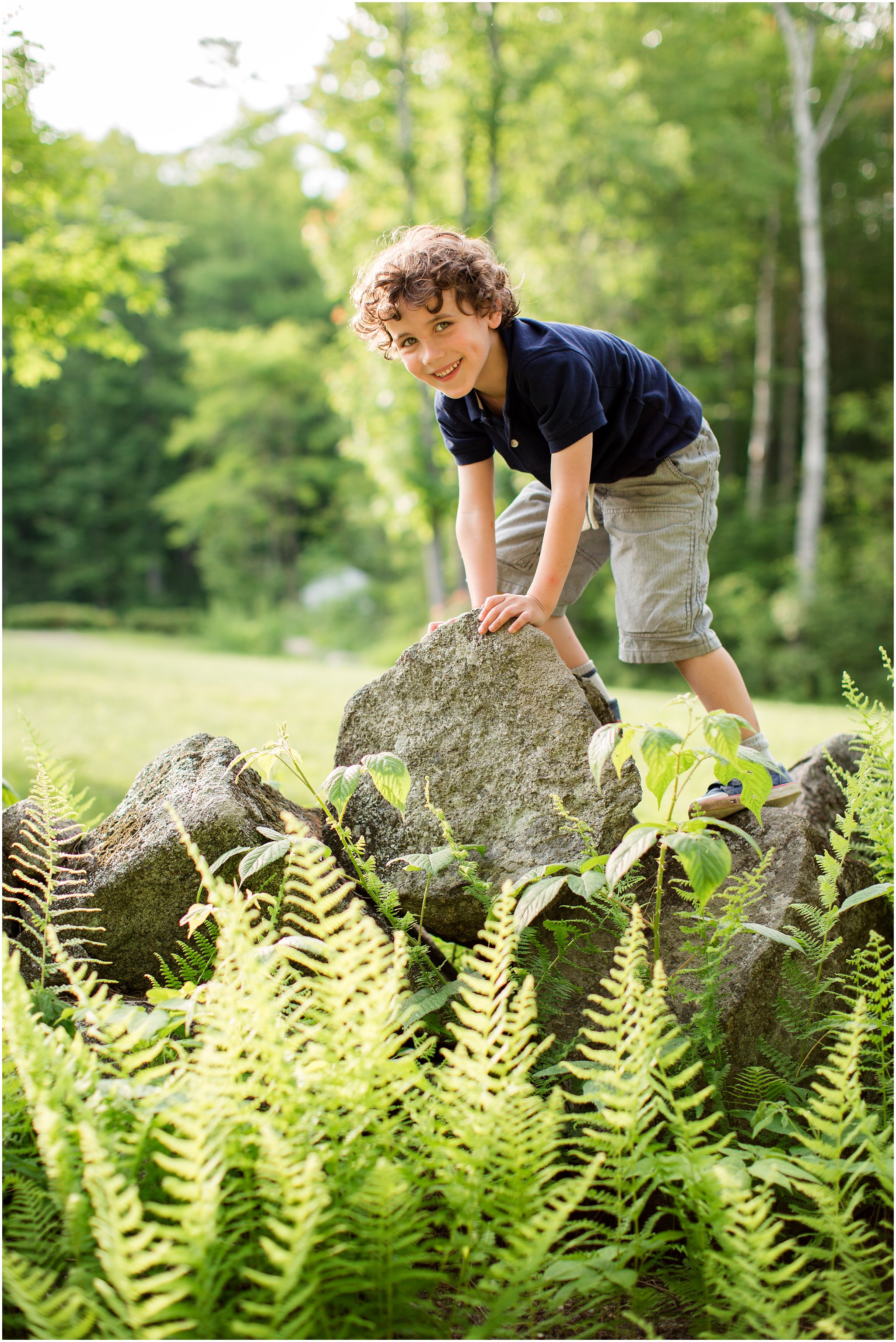 Boy climbing stone wall