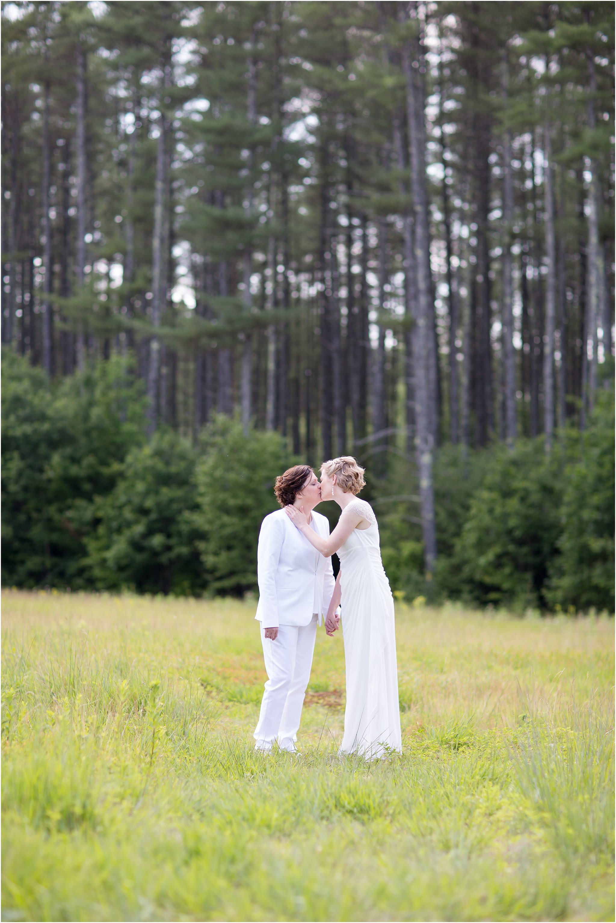 Two brides kissing