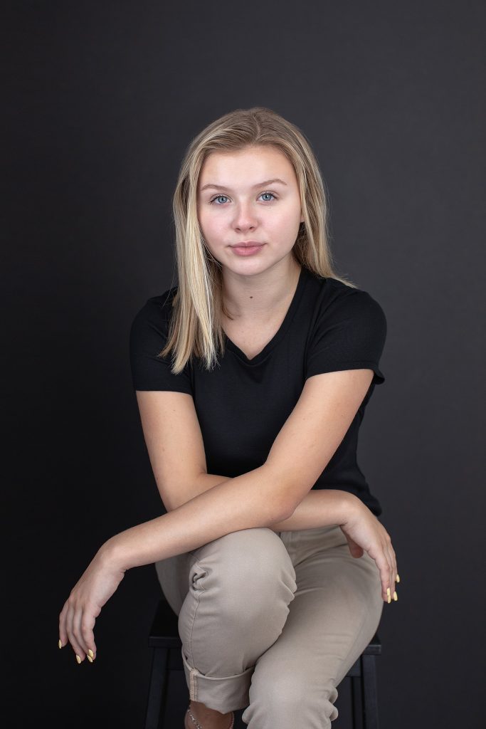 Seated actor portrait on black background