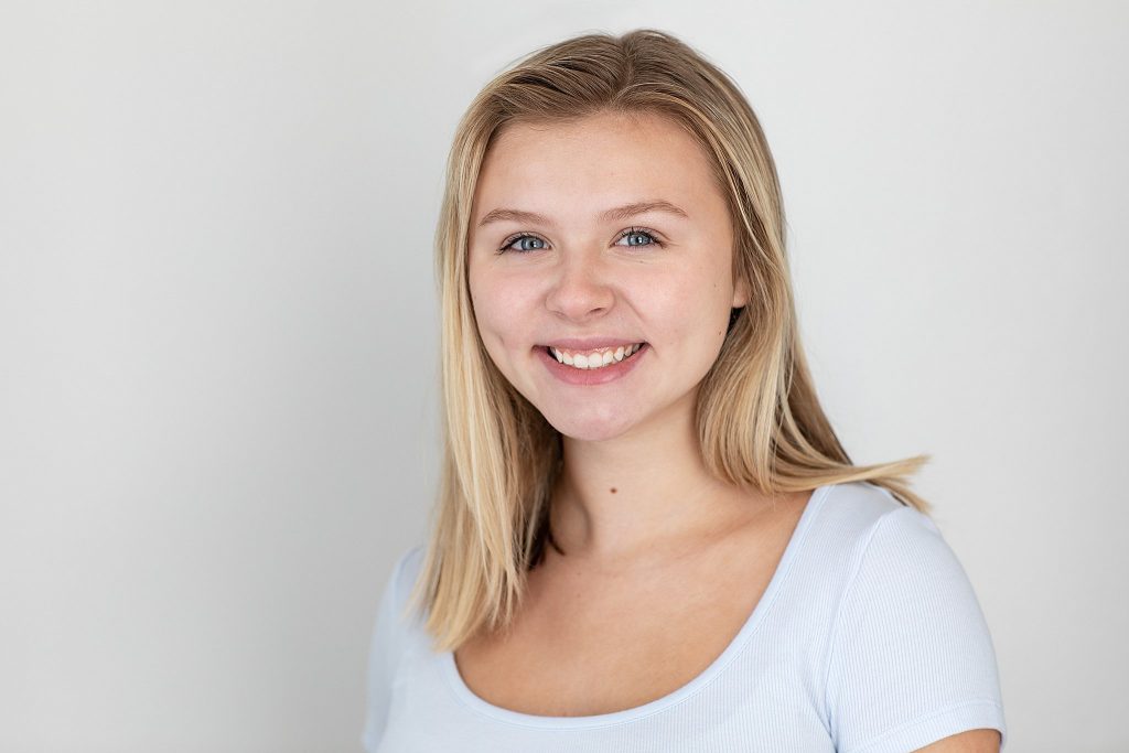Smiling actor headshot on light background