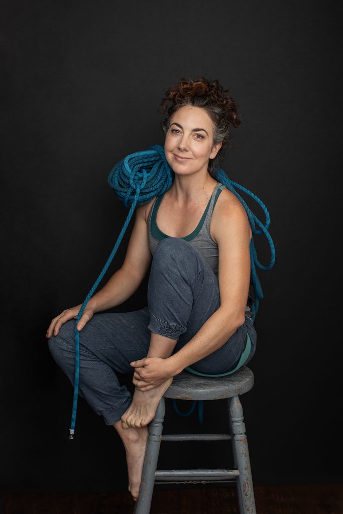 Portrait of Kayte with rock climbing gear