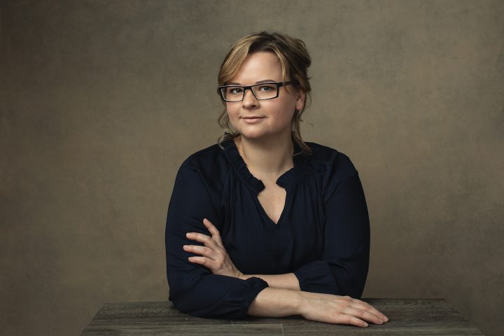 Portrait of Natalie Taylor, owner of Artisan Eyewear, wearing glasses
