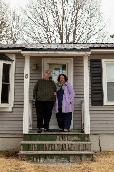 Jonathan and Marcia, outside their home