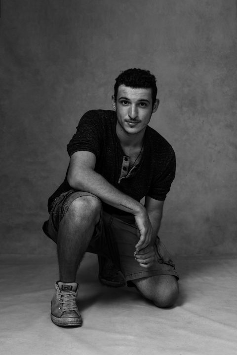 Black and white portrait of white man, kneeling in protest and solidarity with the BLM movement.