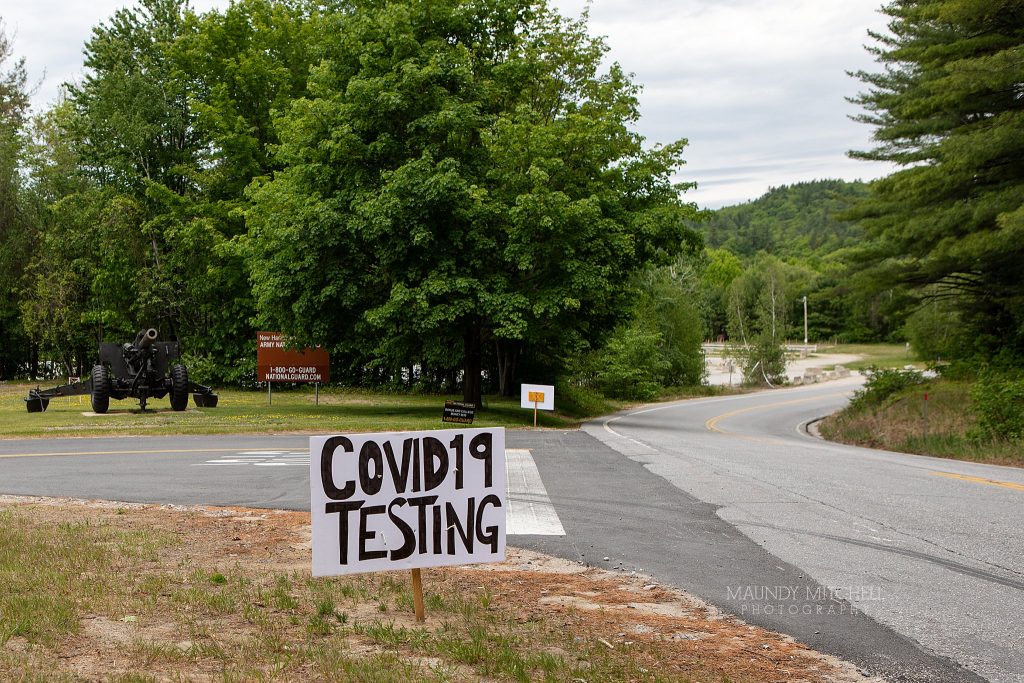 A hand-painted "COVID-19 TESTING" sign at the National Guard Armory in Plymouth, NH