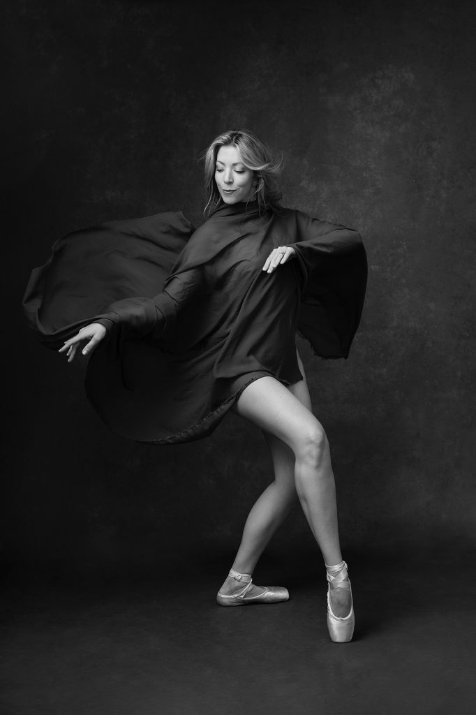 Black and white portrait of dancer in fabric with pointe shoes