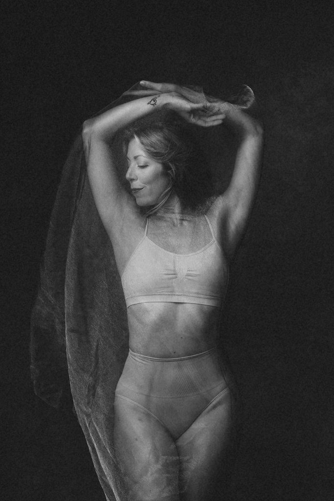 Black and white portrait of dancer in sheer fabric