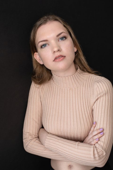 Portrait of teenage girl with dark background