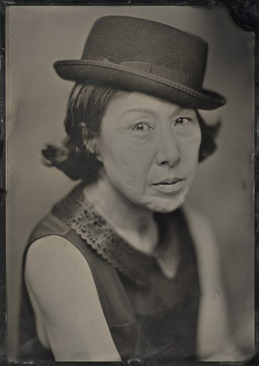 A wet plate collodion / tintype (ferrotype) portrait of Hwakyung Chang wearing a hat