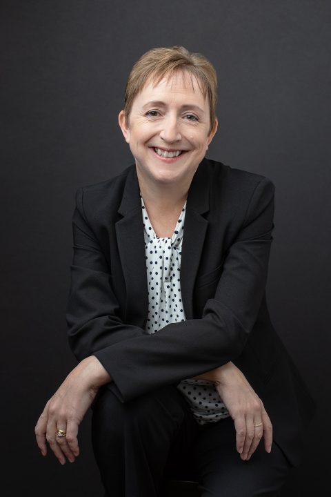 Personal branding portrait with black background for Realtor Tracey Bennett