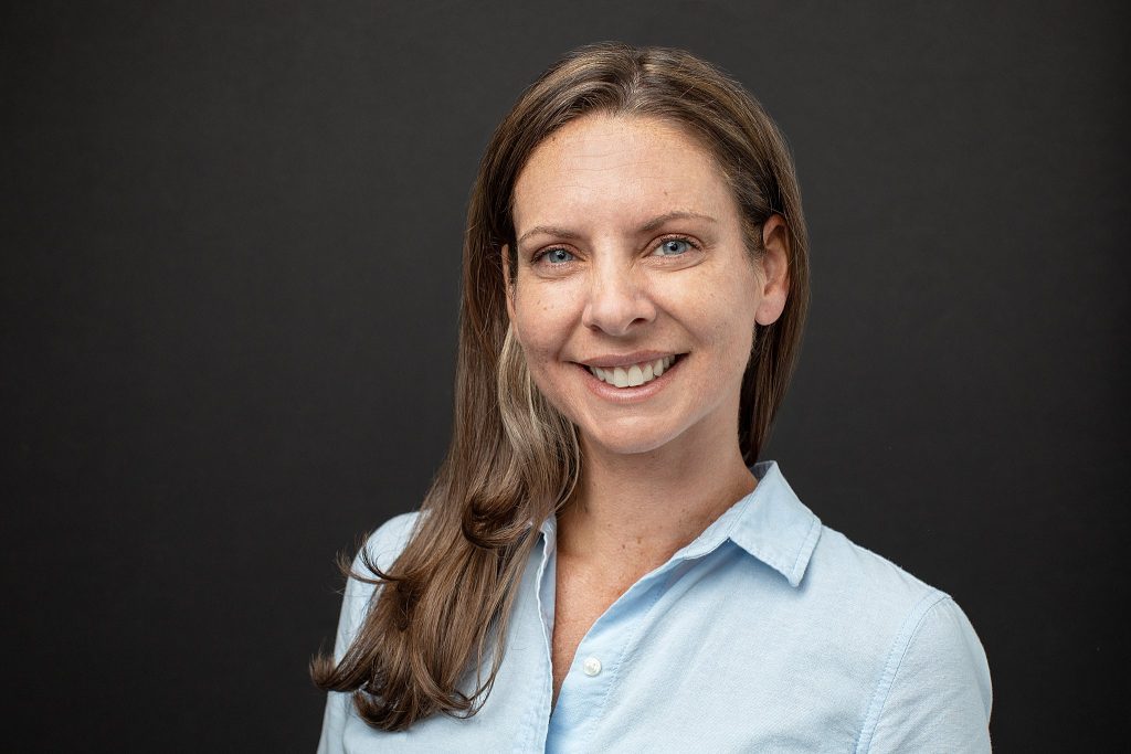 A professional headshot with a black background