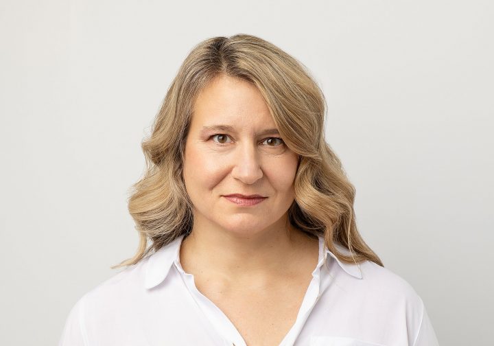 A headshot of Amanda for Extraordinary: the Over 50 Revolution - she is wearing a white shirt in front of a white background