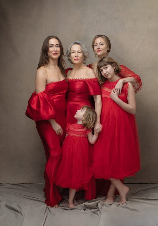 Three generations wearing red dresses