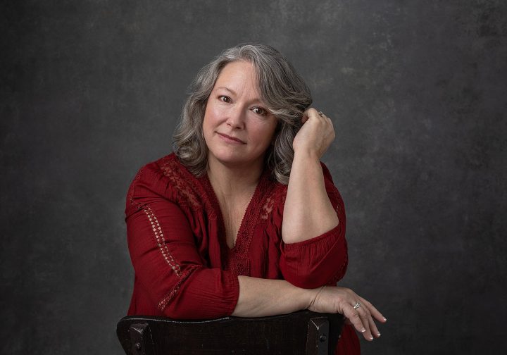 Nicole, wearing red for her portrait experience, Extraordinary: the Over 50 Revolution