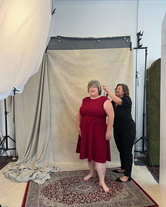 Behind the scenes - Taunya wearing a red dress for the Over 50 Revolution. Hair and makeup by Donna Cotnoir