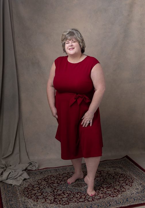 Portrait of Taunya wearing a red dress for Extraordinary: the Over 50 Revolution