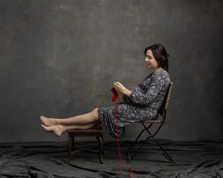 Knitted Together, Part XIII: Toni
Toni is a pregnant woman who is sitting with her bare feet up, knitting a red bootie for her unborn baby