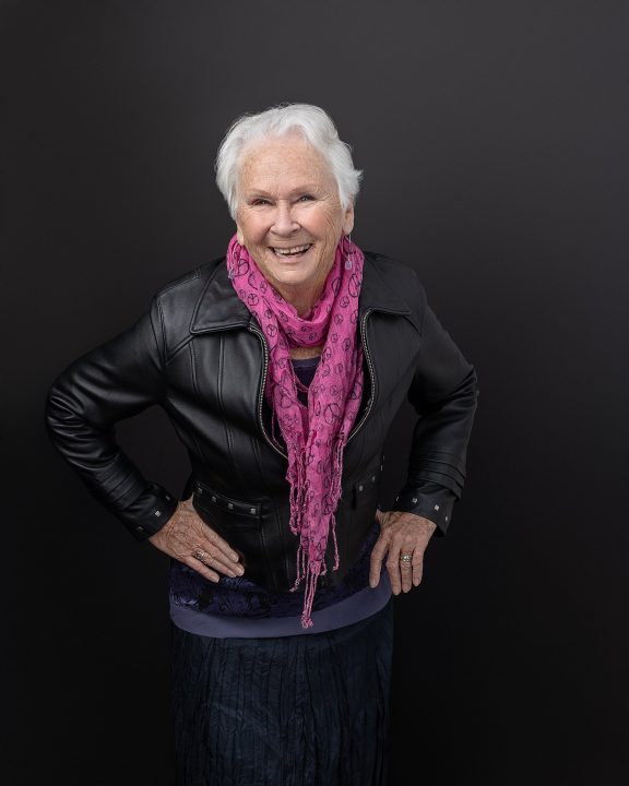 Portrait of Ginny, laughing, wearing a black leather jacket