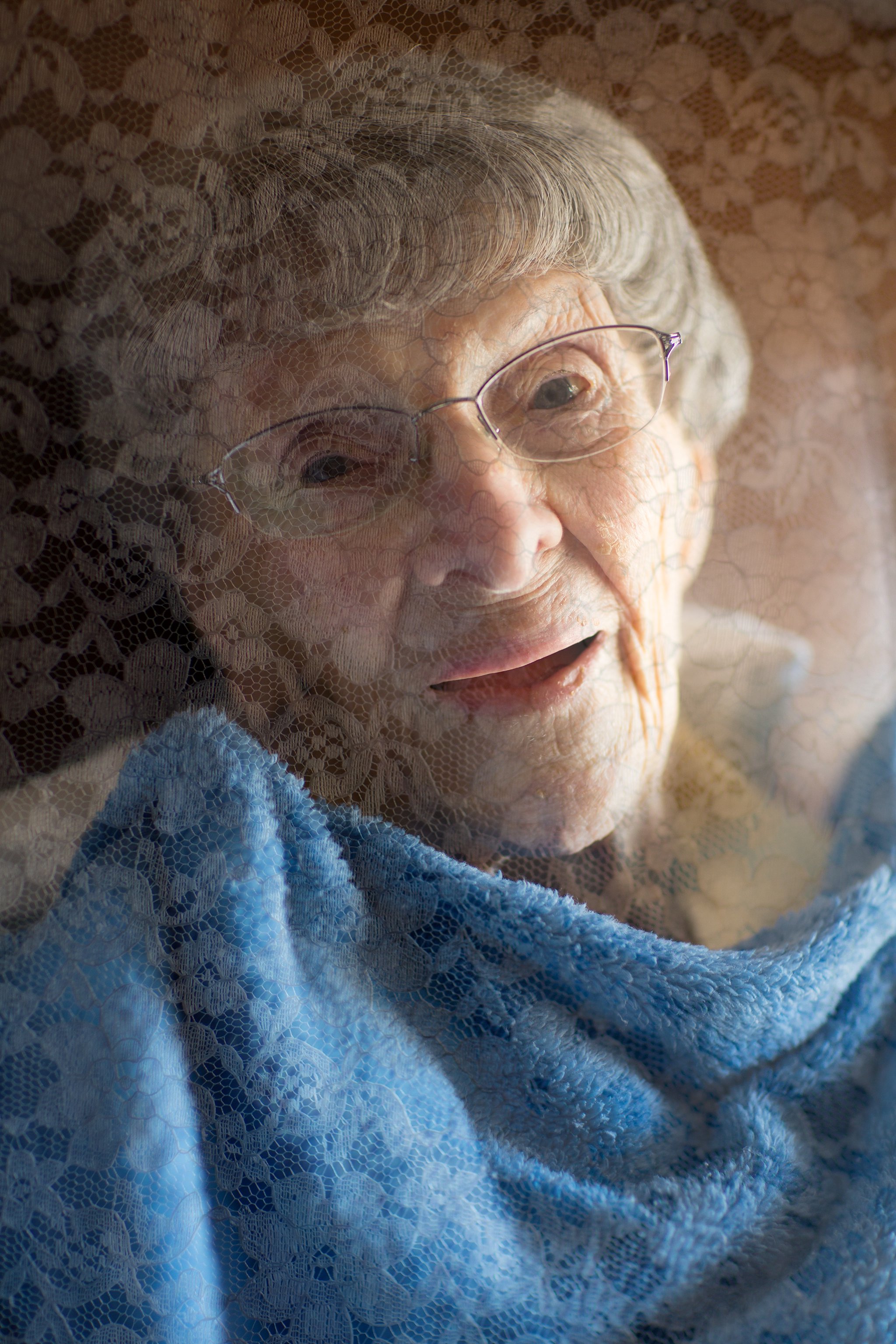 Portrait of Elderly Woman, Photographed Through Lace