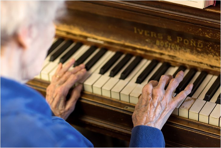 elderly woman playing piano