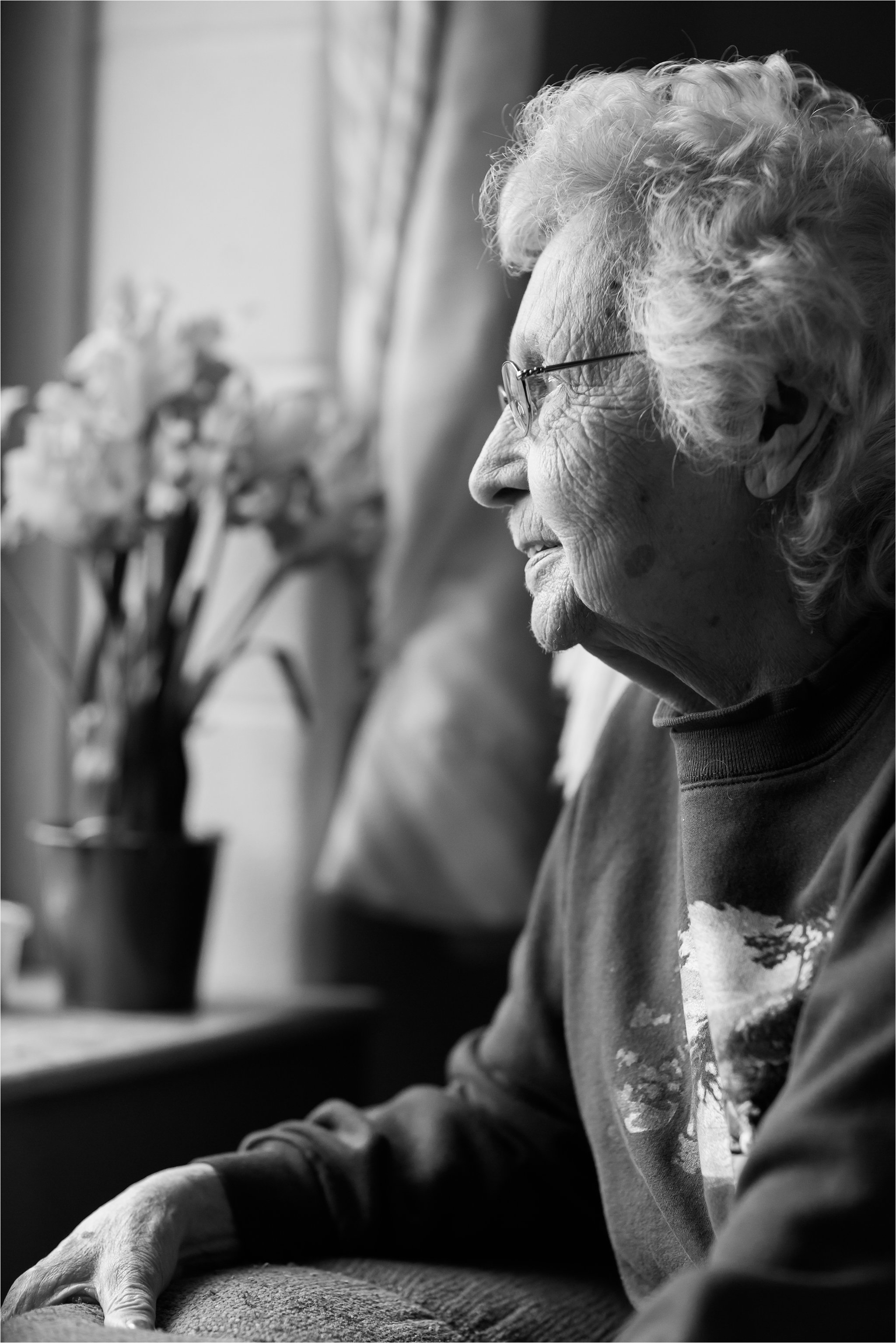 Black and White Portrait of Elderly Woman at Window