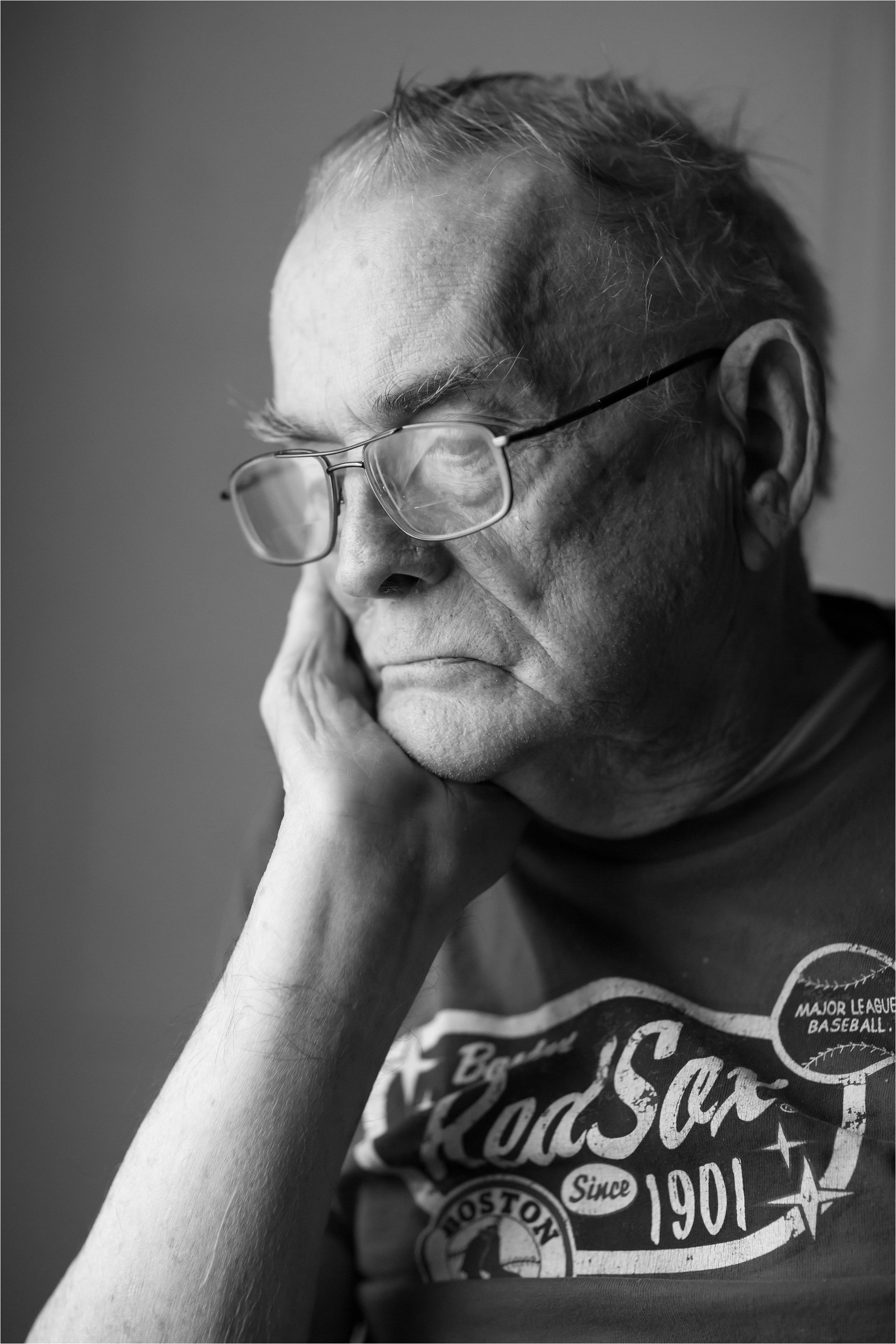 Black and White Portrait of Elderly Man Wearing Red Sox Shirt