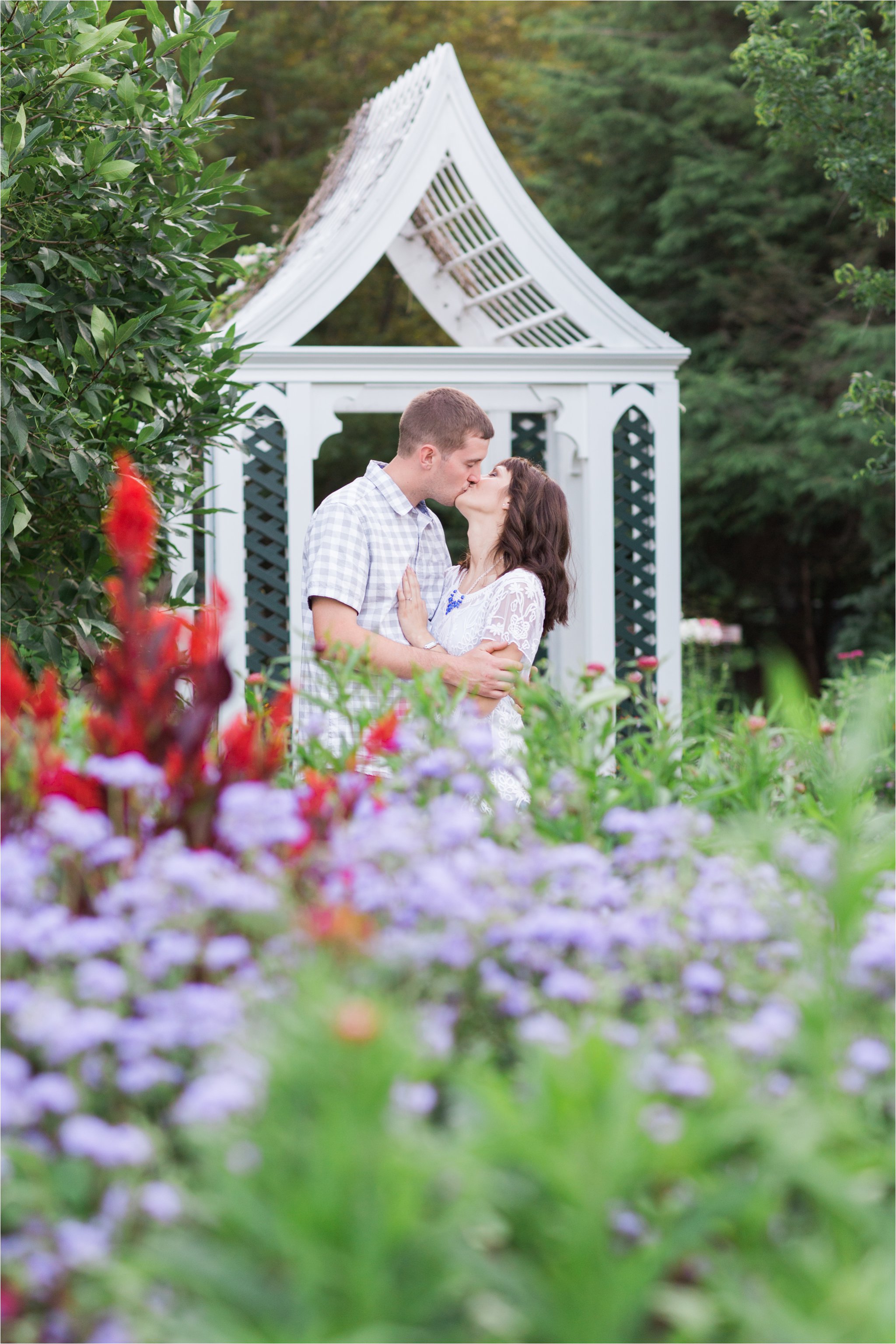Engaged Couple Kissing in Garden (C) Maundy Mitchell