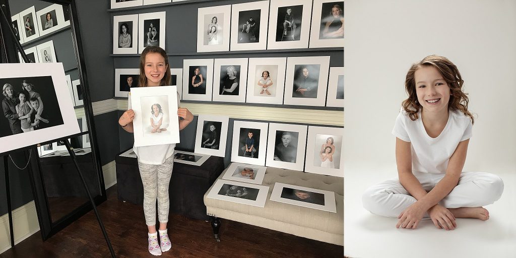 A girl with her favorite portrait from her family's session