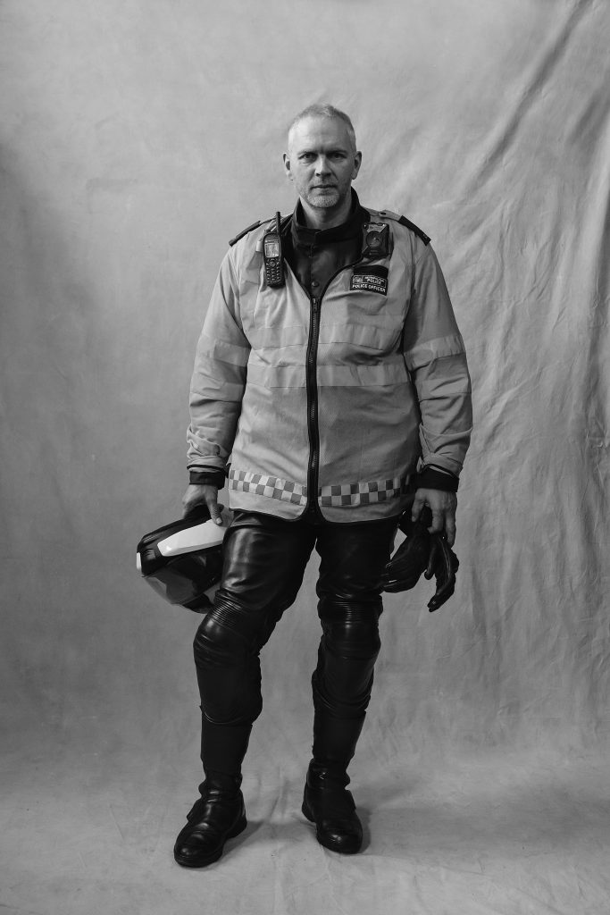 London Traffic Officer Holding Helmet