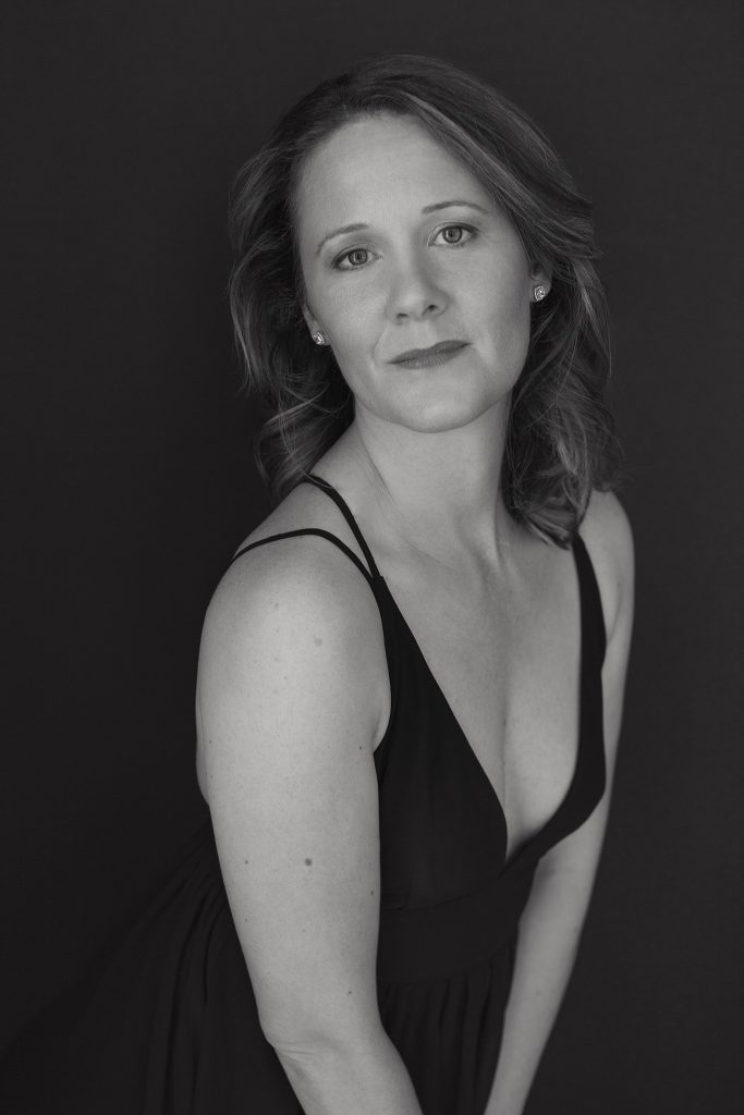 Low key, black and white portrait of Rebecca in a black dress