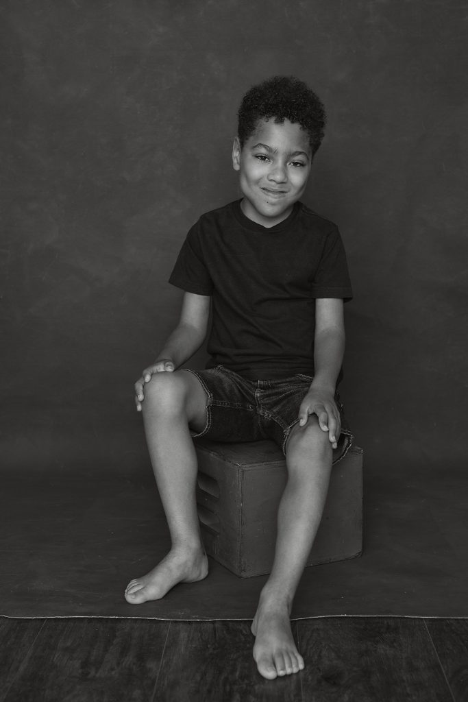 Black and white portrait of Liam with a dark background