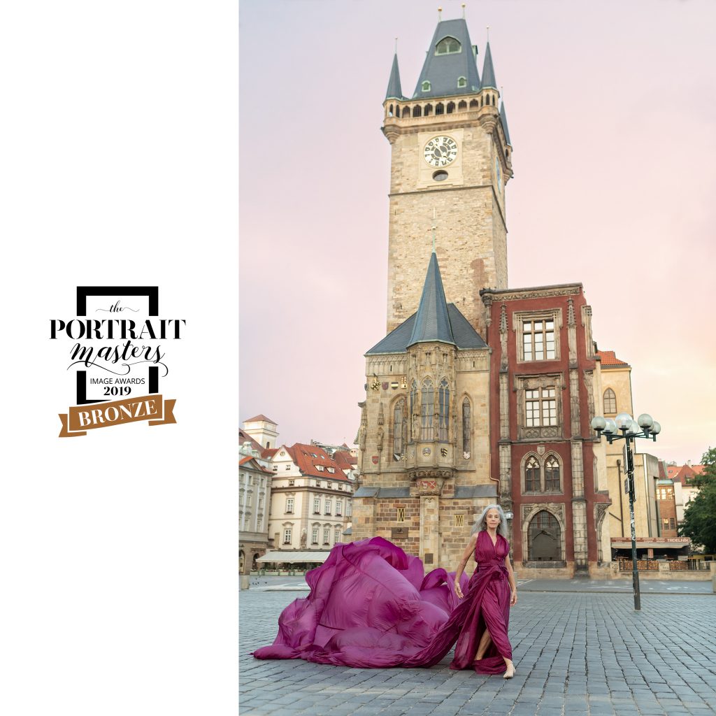 Portrait of a dancer with flowy pink dress in Old Town Square, Prague.  Bronze award in contemporary portraiture: Lisa in Prague.