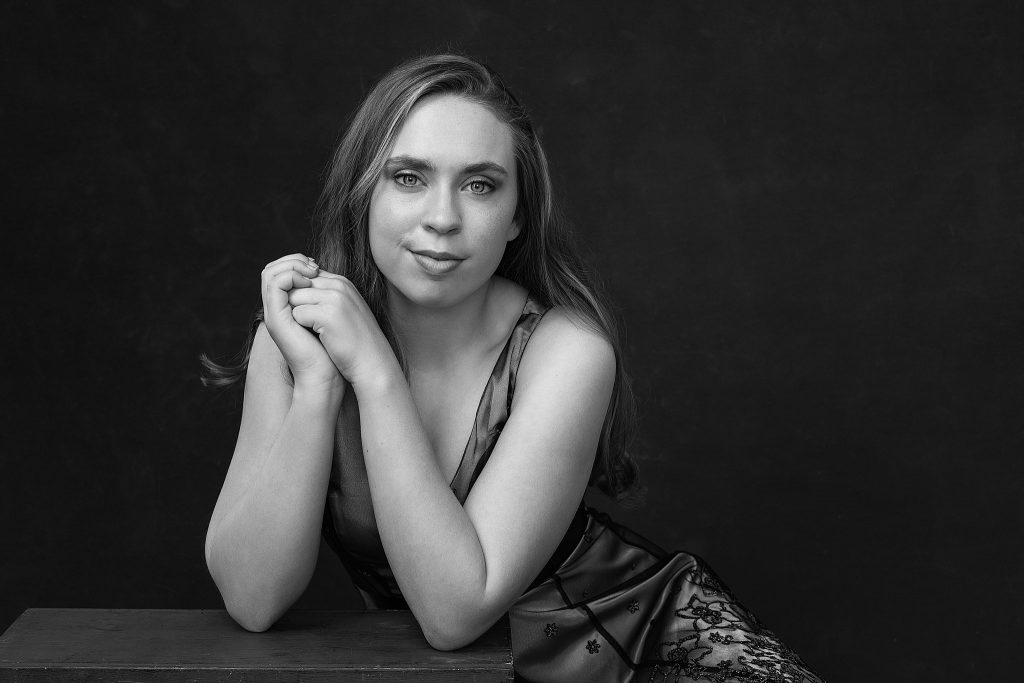 Black and white portrait of Kenzie in tea-length dress