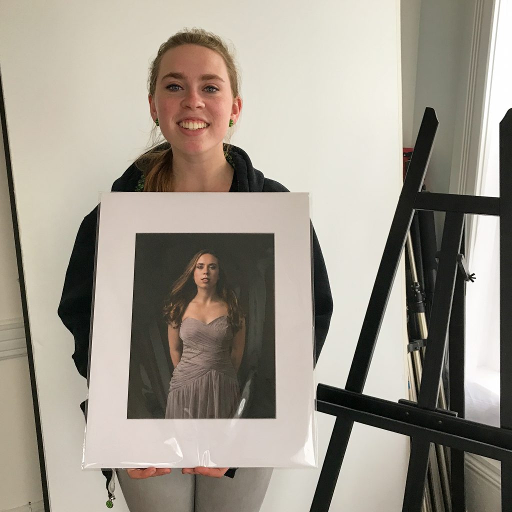 Kenzie, with one of her portraits at her Print Reveal Session.