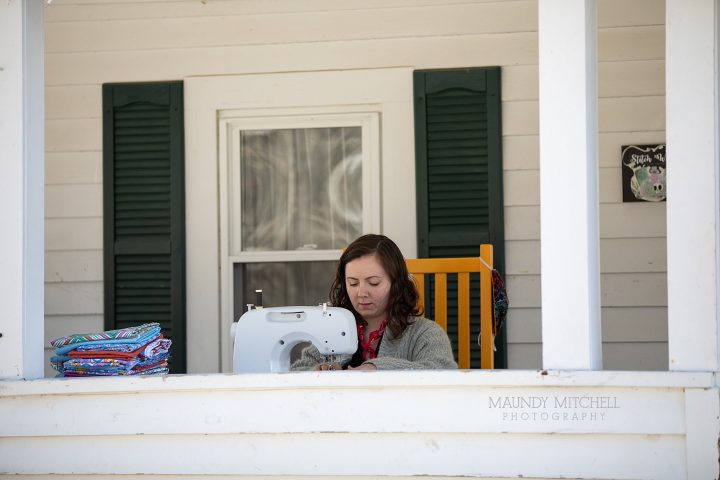 Estee sews masks on her porch