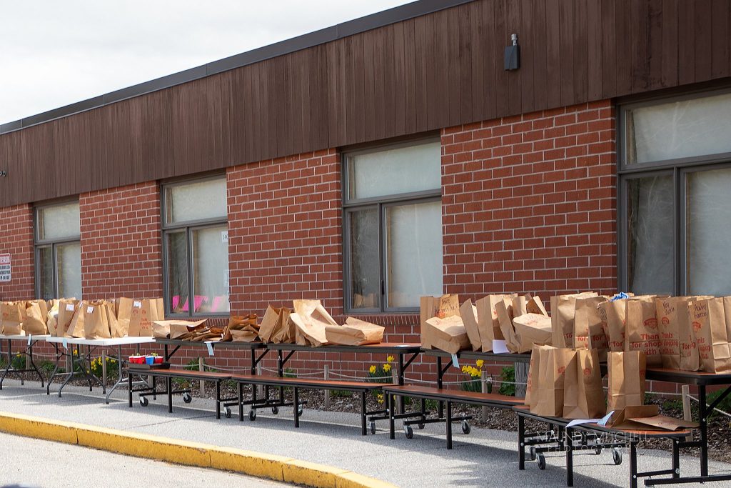 At Campton Elementary School, rows of bags outside are ready for students to pick up.  They contain the contents of each student's locker after it was determined that schools would not reopen.