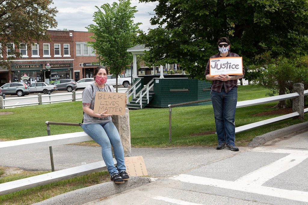 Protesters on the Plymouth, NH town common, holding signs that read "Black Lives Matter" and "Justice"