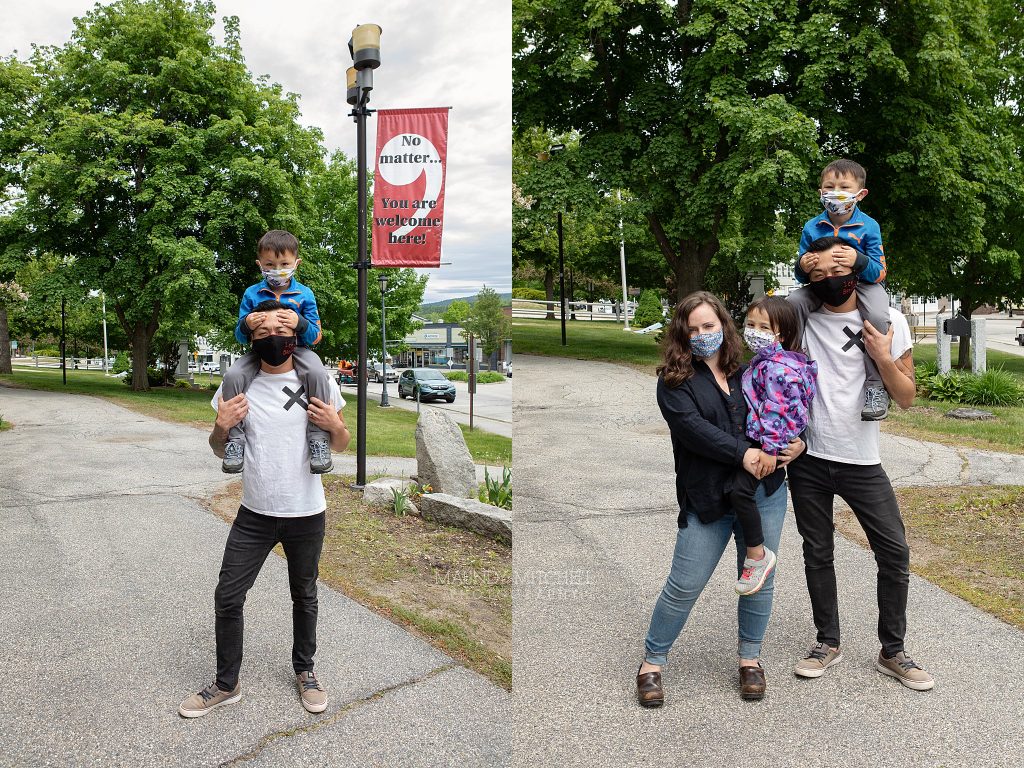 A family on the sidewalk, all wearing masks