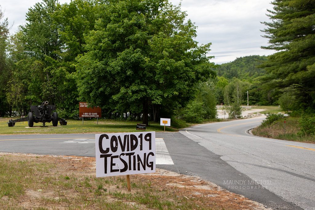 A hand-painted "COVID-19 TESTING" sign at the National Guard Armory in Plymouth, NH