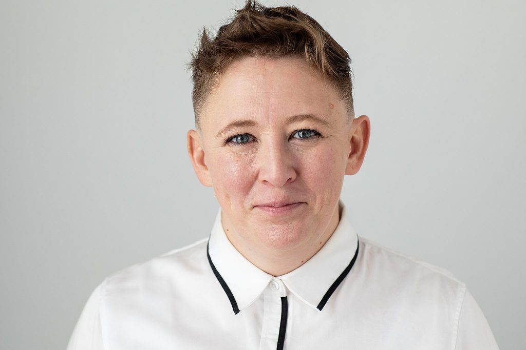 headshot of Jini wearing white shirt on light background