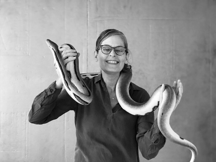 photographer Maundy Mitchell holding Otto, a Reticulated Python