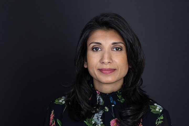 Business headshot with dark background - Shwetha wearing a patterned shirt