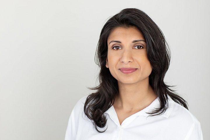 Business headshot with light background - Shwetha wearing white shirt